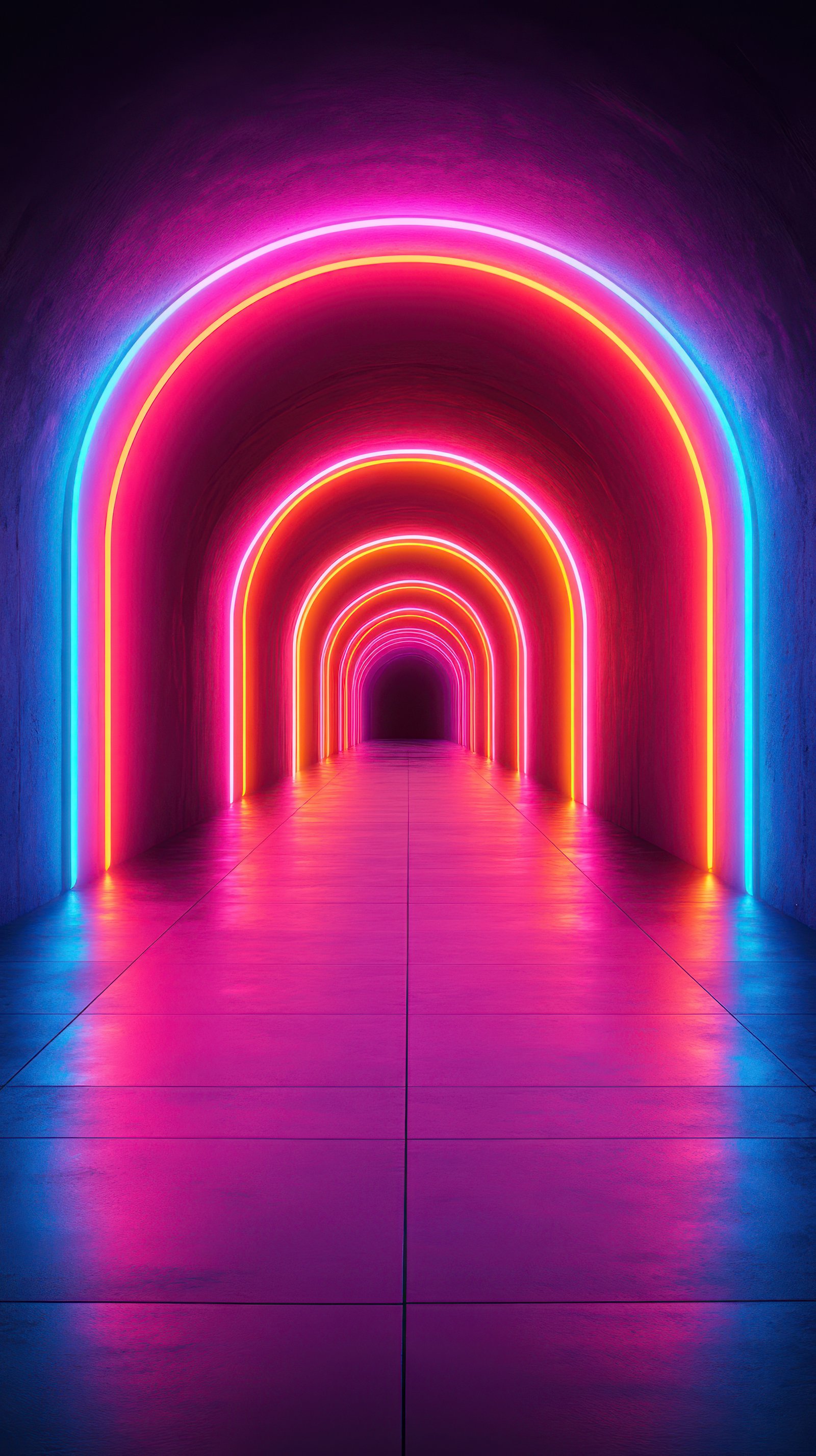 Colorful neon arches create a vibrant tunnel effect in a darkened space at night